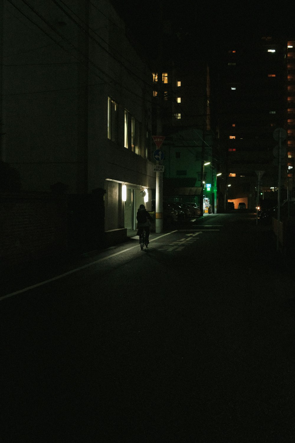 a person walking down a dark street at night