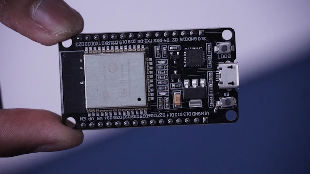 a close up of a person holding a small electronic device