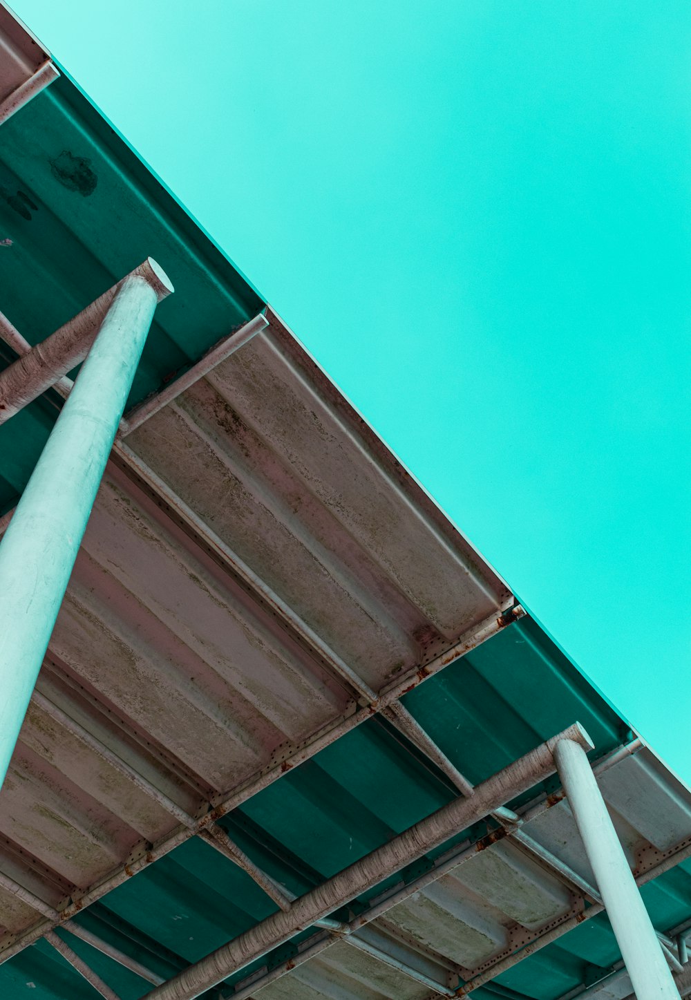 a stop sign on a pole in front of a blue sky