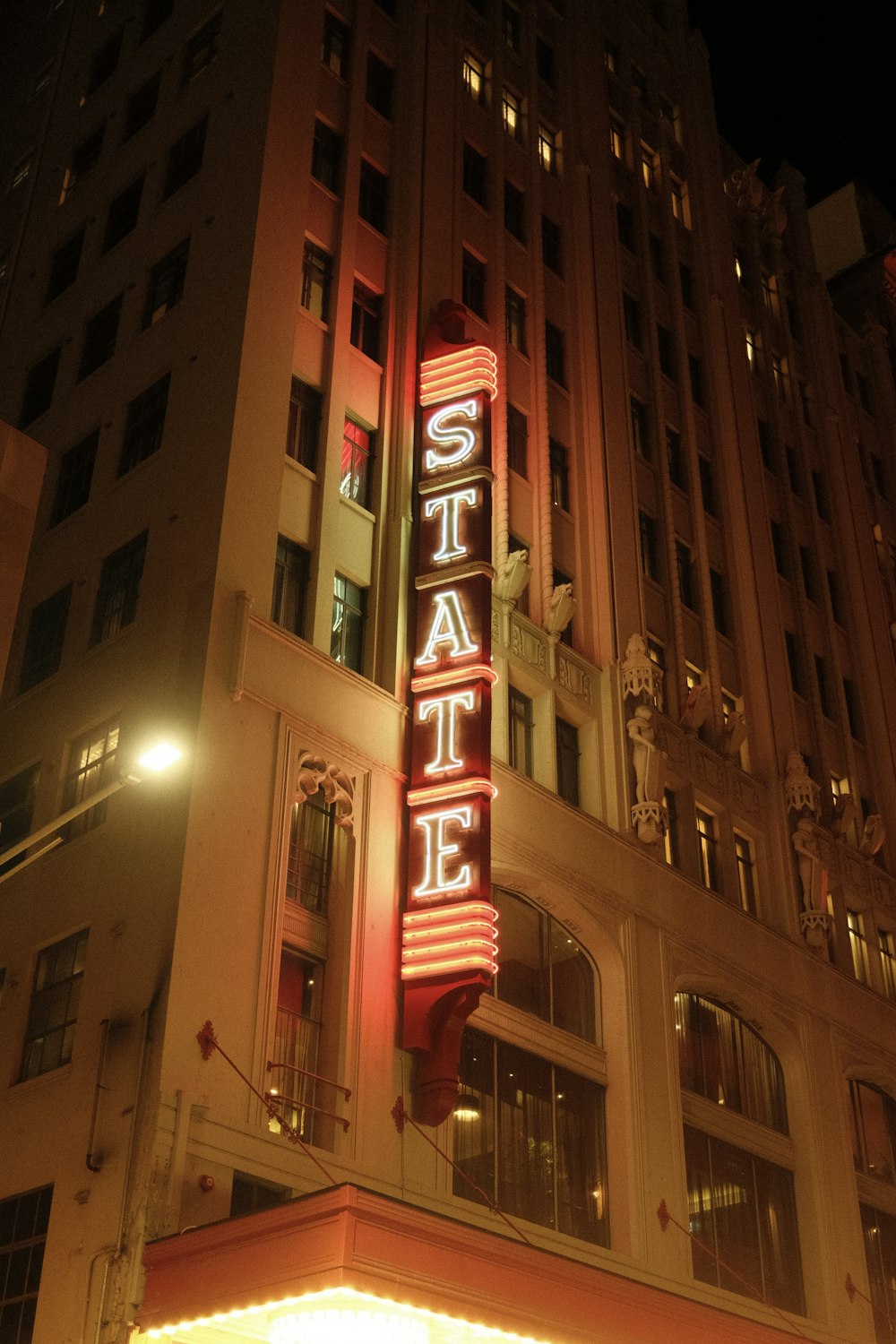 the state theatre sign is lit up at night