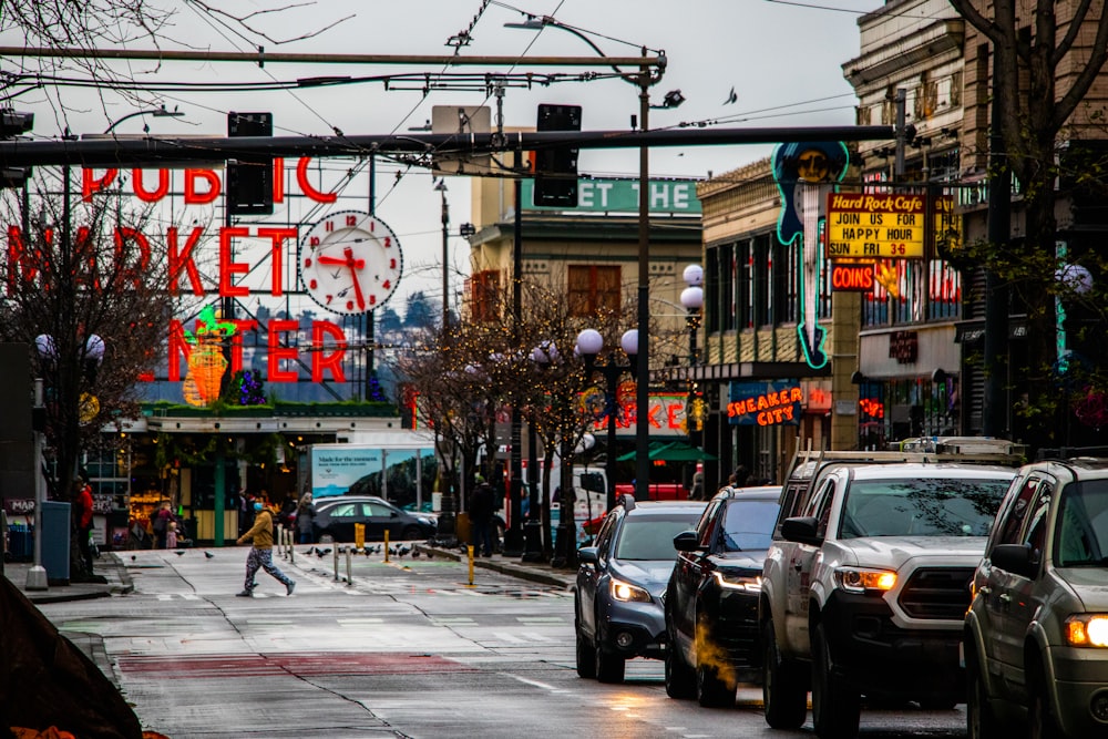 a city street filled with lots of traffic next to tall buildings