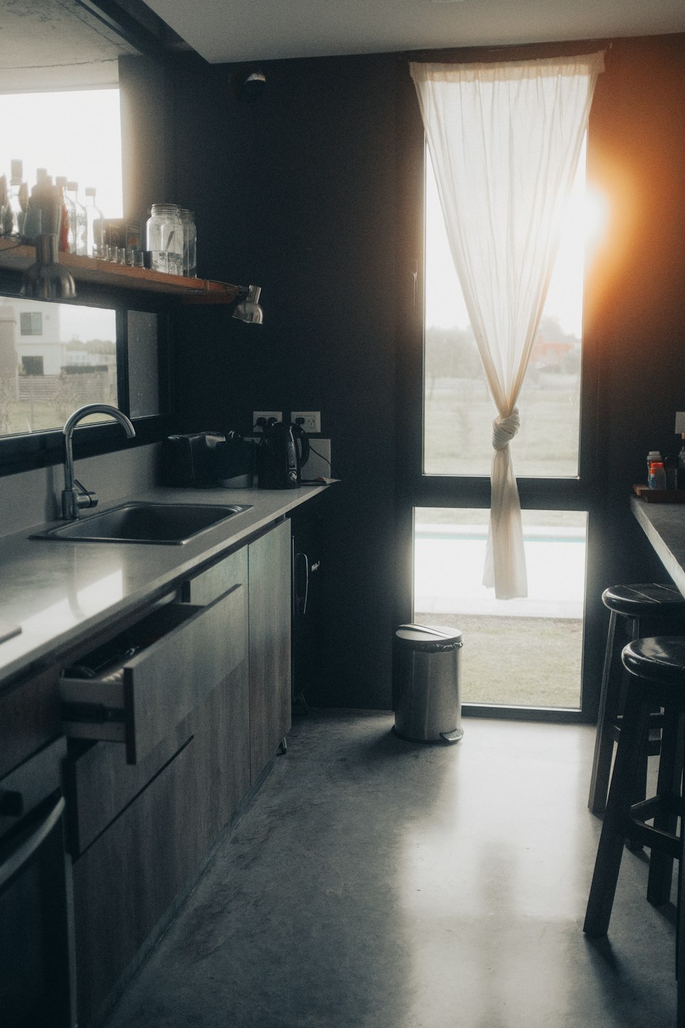 a kitchen with a sink a counter and a window