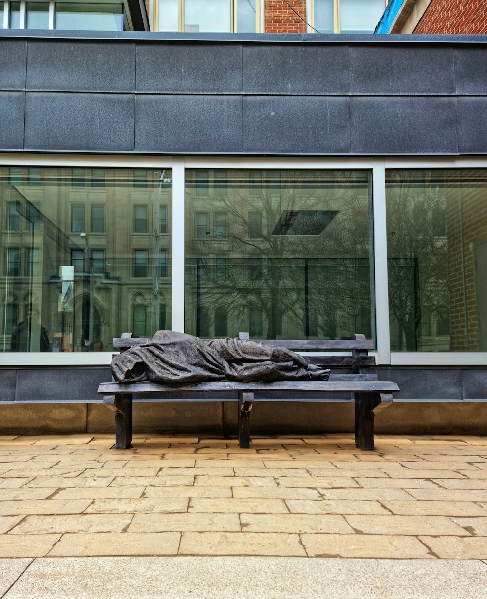 a black bench sitting in front of a building