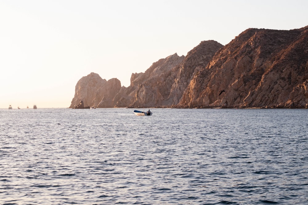 a small boat in the middle of a large body of water