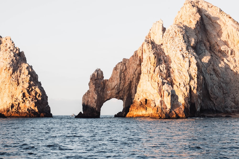 a large rock formation in the middle of the ocean