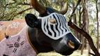 a statue of a bull in a forest