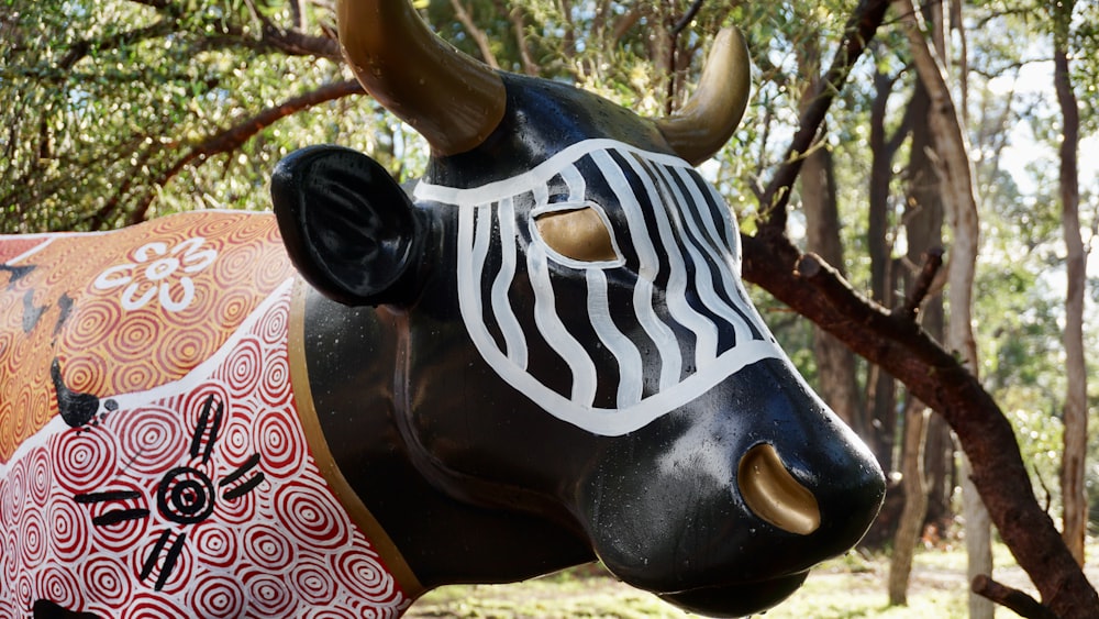 a statue of a bull in a forest