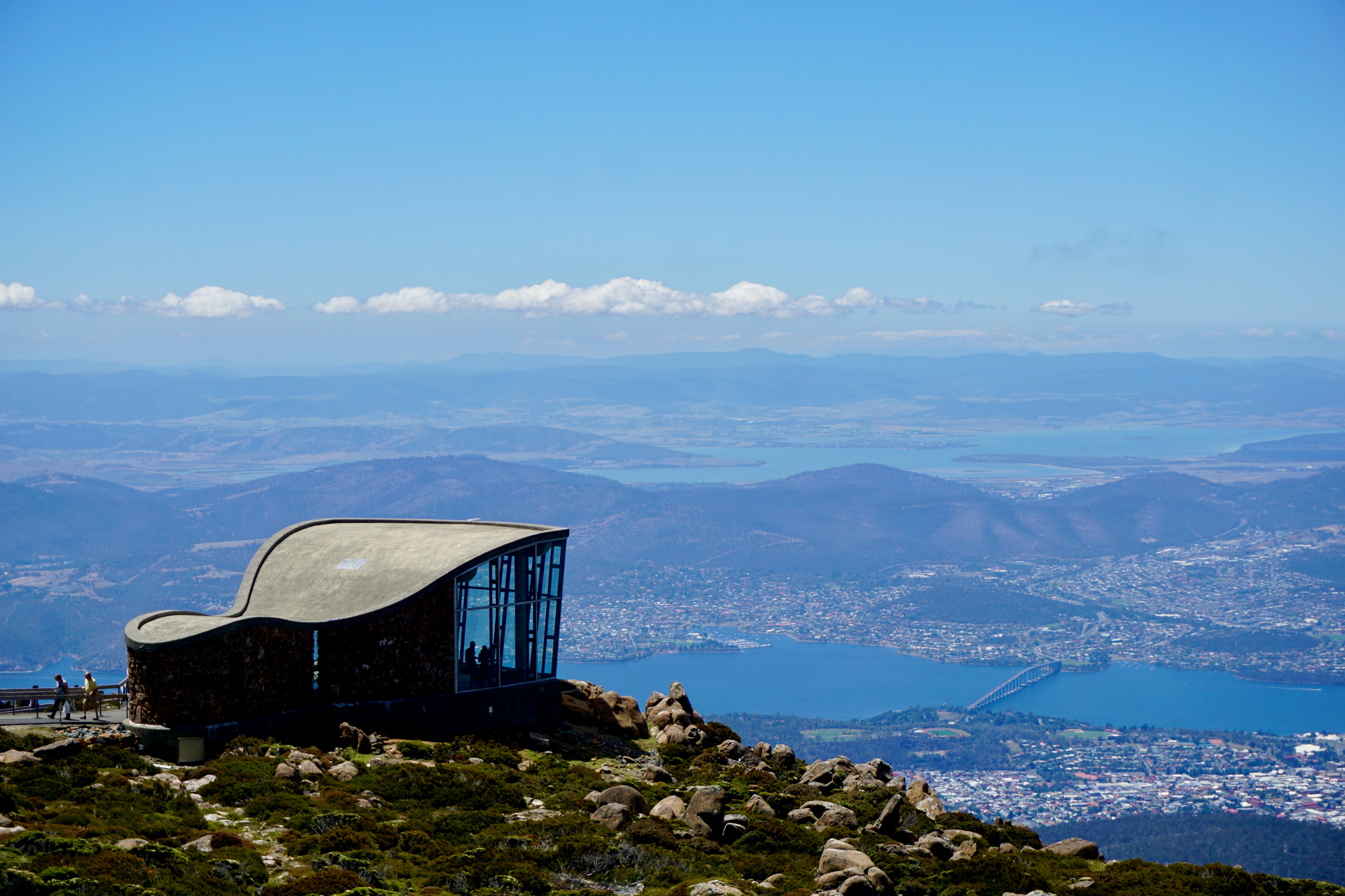 a building on top of a mountain with a view of a city below