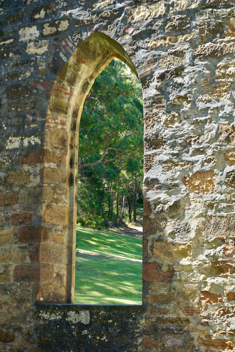 a stone wall with a window in it