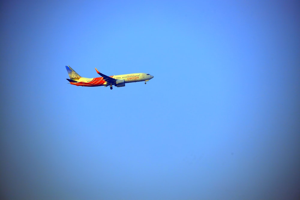 an airplane is flying in the blue sky