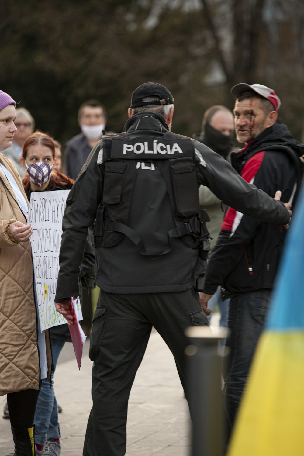 a police officer standing next to a crowd of people