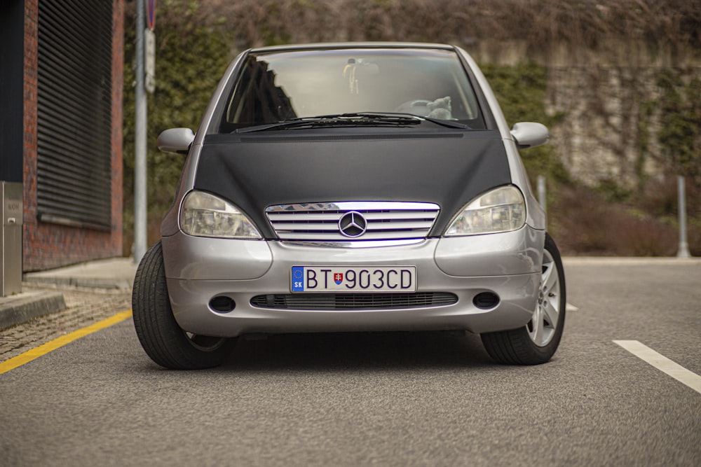 a silver car parked on the side of the road