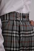 a close up of a person wearing plaid pants