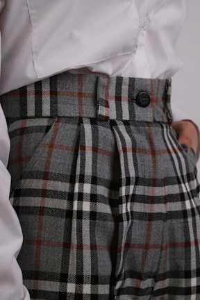a close up of a person wearing plaid pants