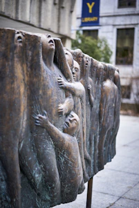 An evocative art installation featuring figurative sculptures and vibrant paintings that embody transformation and courage.