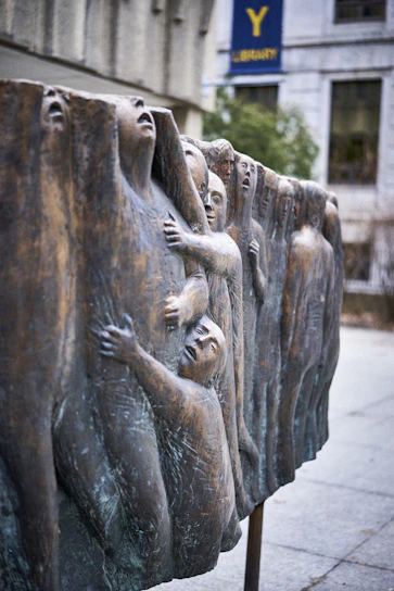 An evocative art installation featuring figurative sculptures and vibrant paintings that embody transformation and courage.