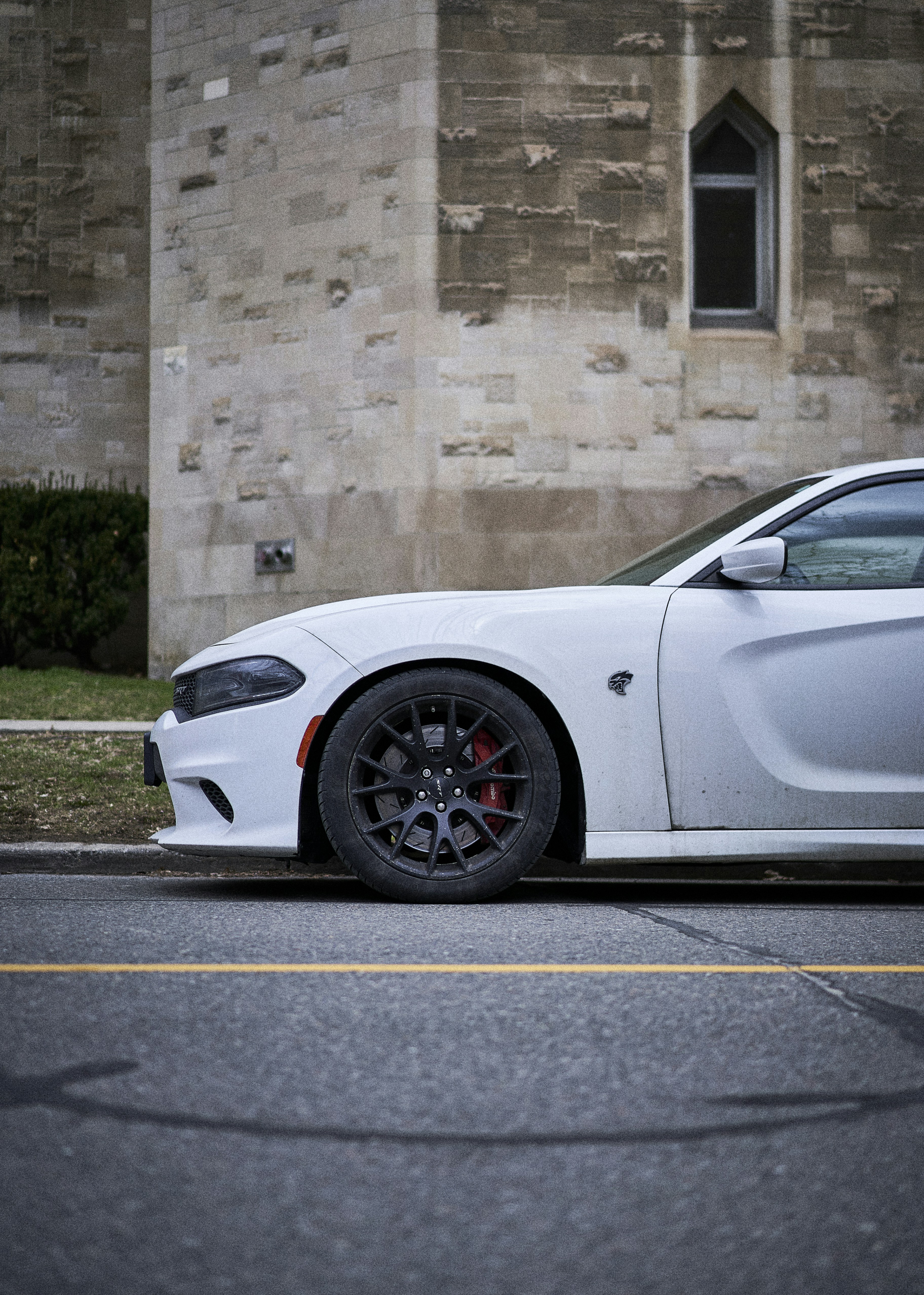 a white sports car parked in front of a building