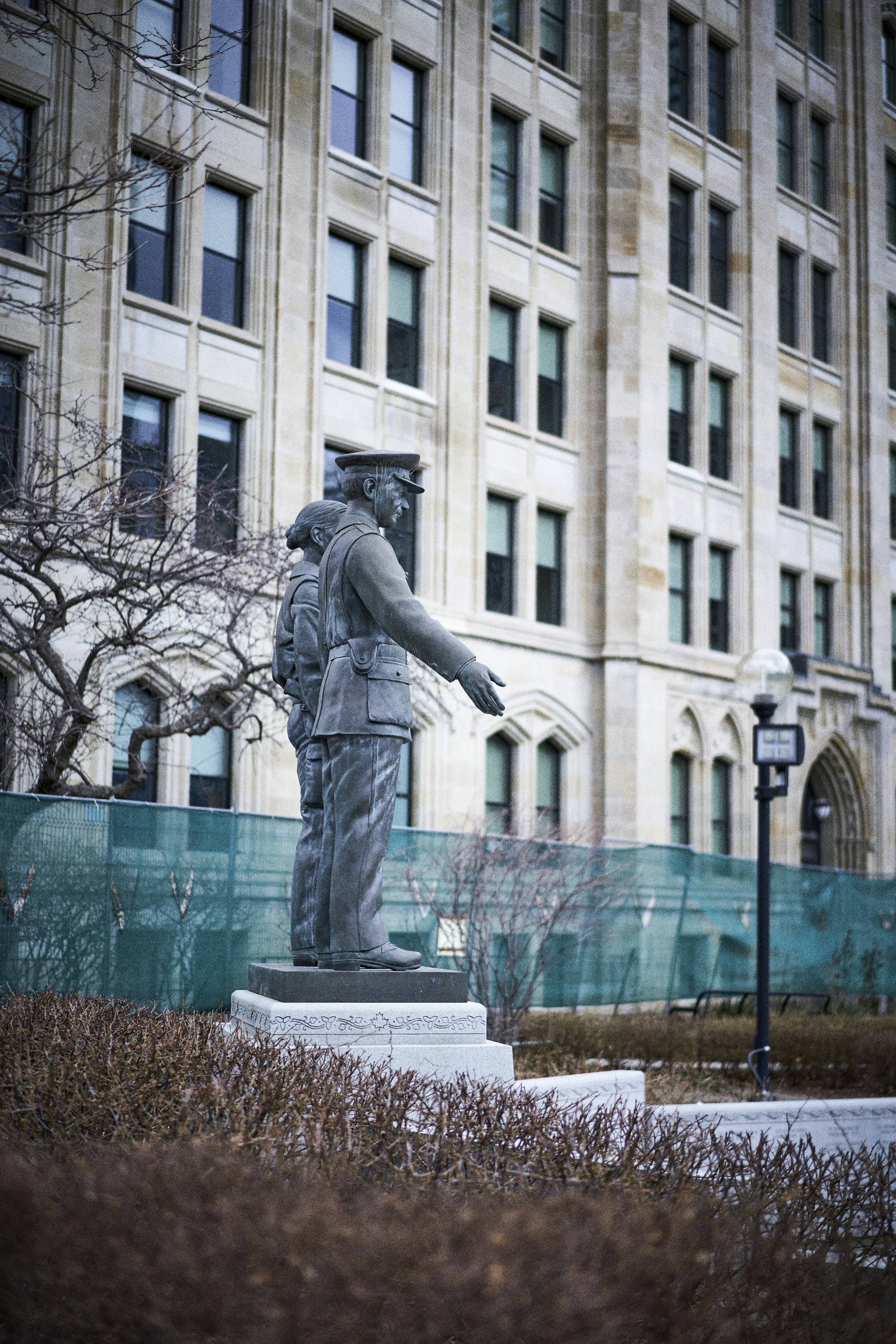 a statue of a soldier in front of a building