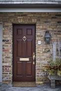 Front door of a London townhouse featuring a sleek lock and handle.