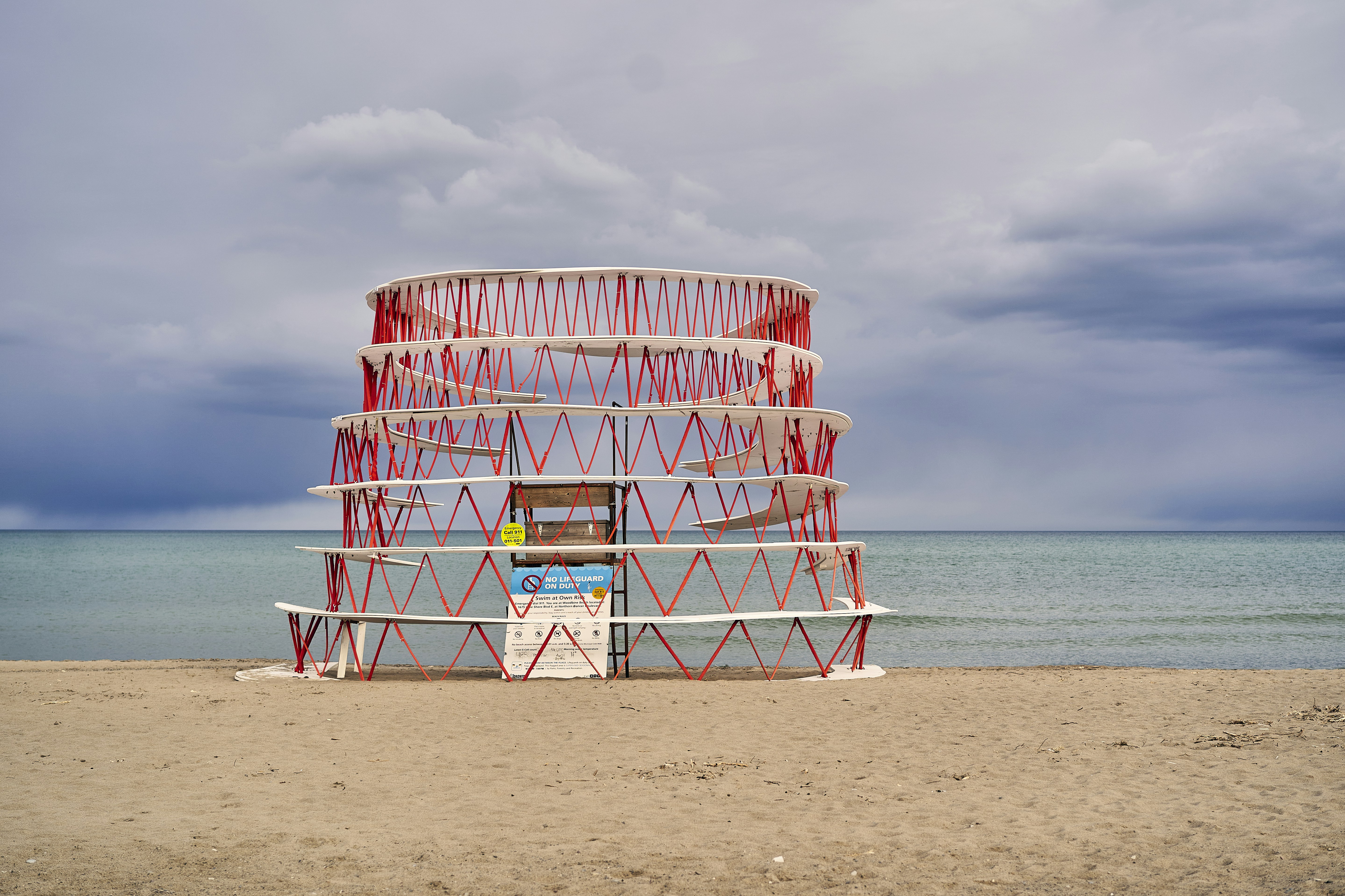 A beach wheel drink cooler on sandy beach with drinks inside