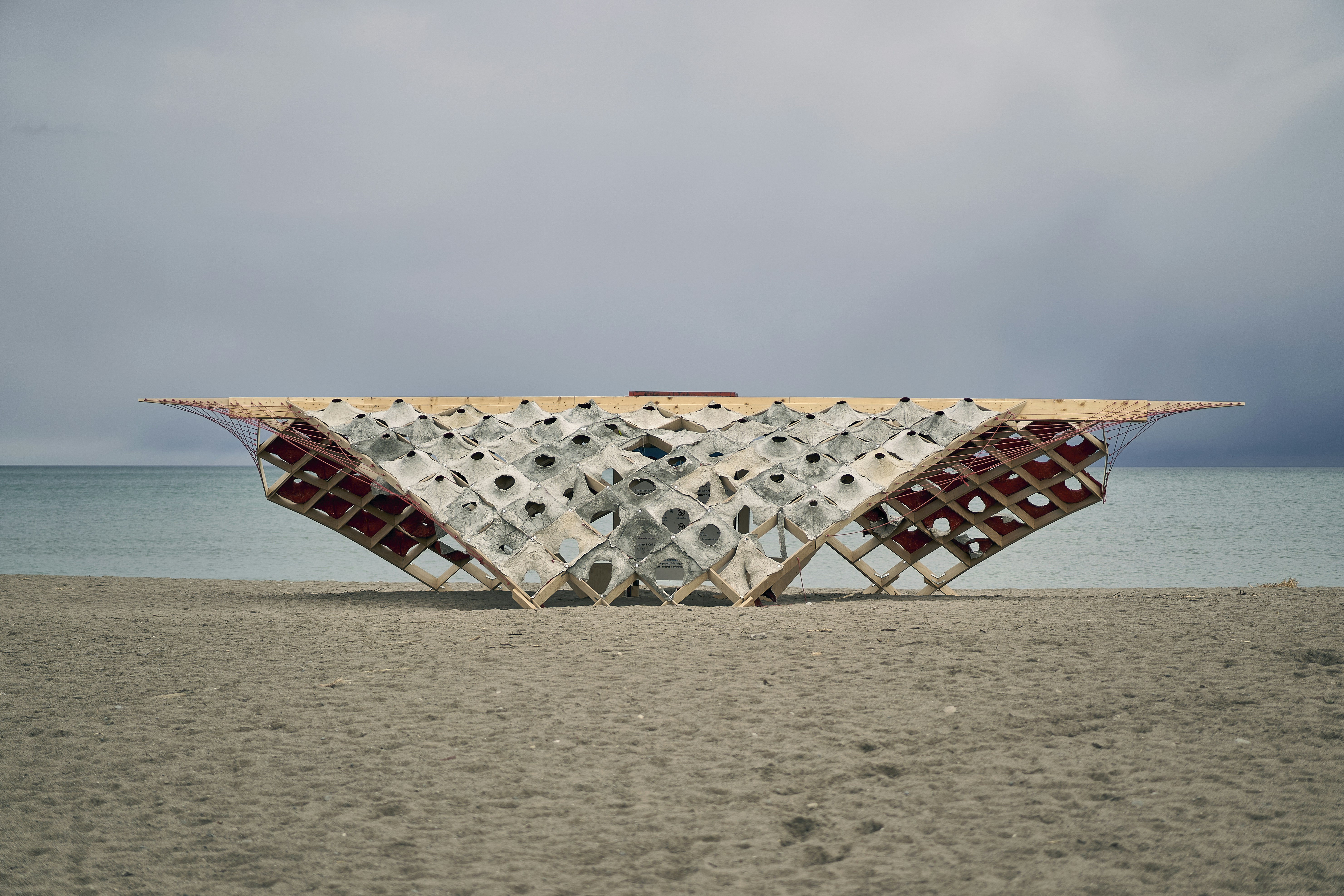 a couple of chairs sitting on top of a sandy beach