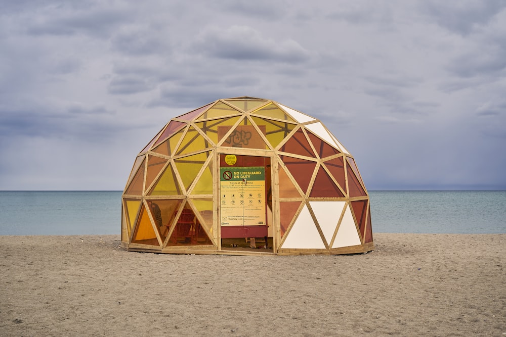 a wooden structure sitting on top of a sandy beach