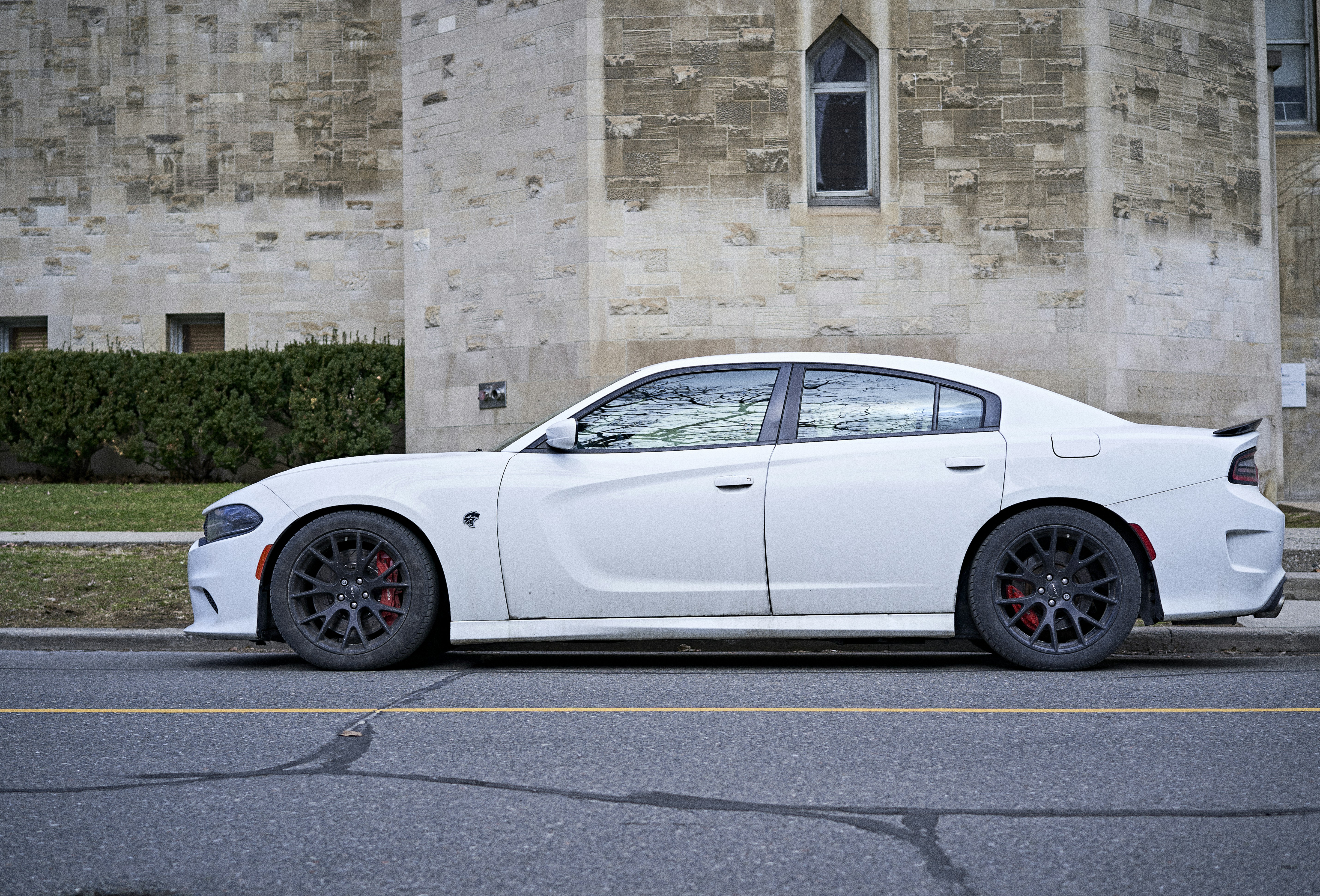 a white sports car parked in front of a building