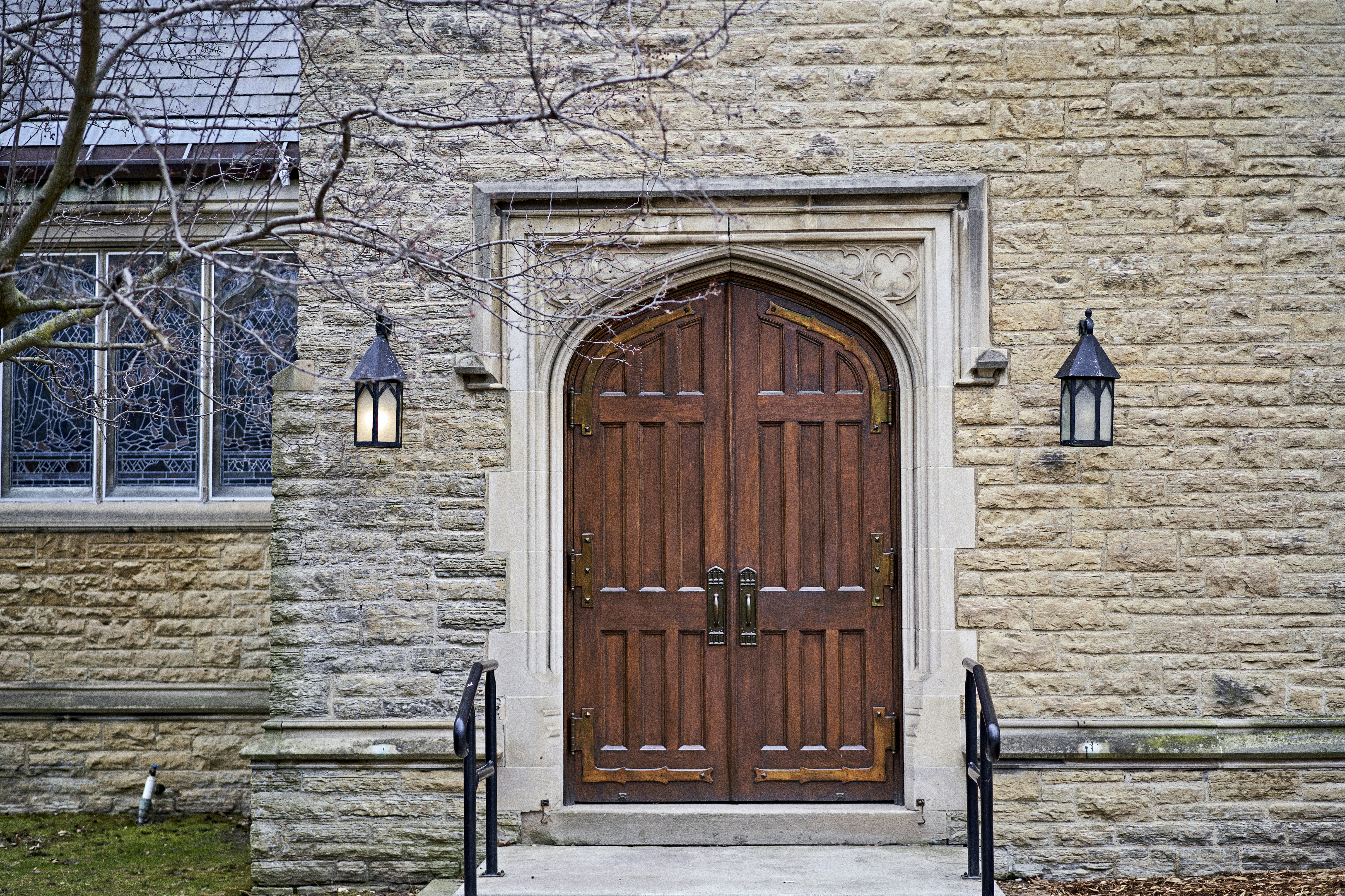 a large wooden door in front of a brick building