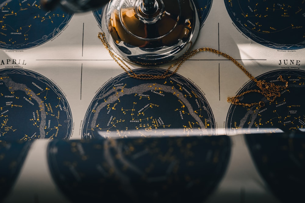 a close up of a clock with zodiac signs on it