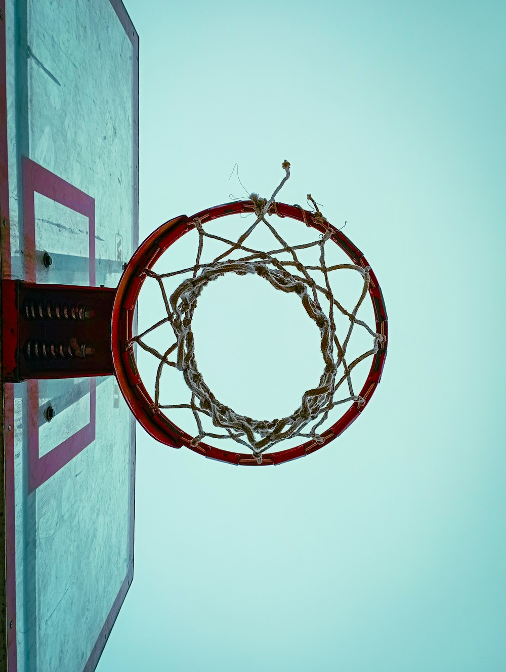 a basketball going through the hoop of a basketball court