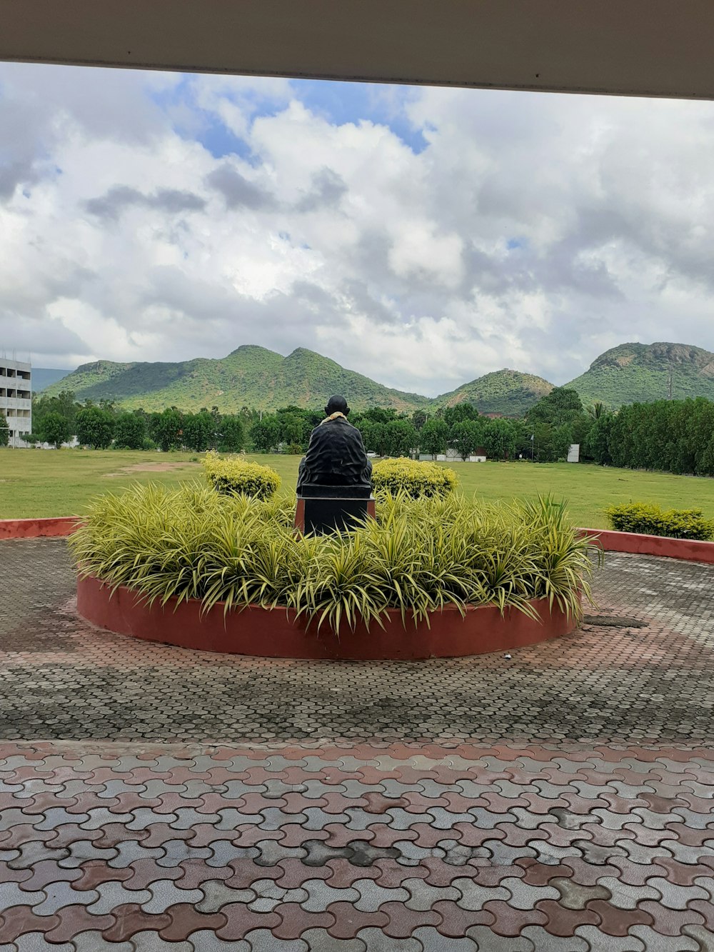 a man sitting on a bench in a park