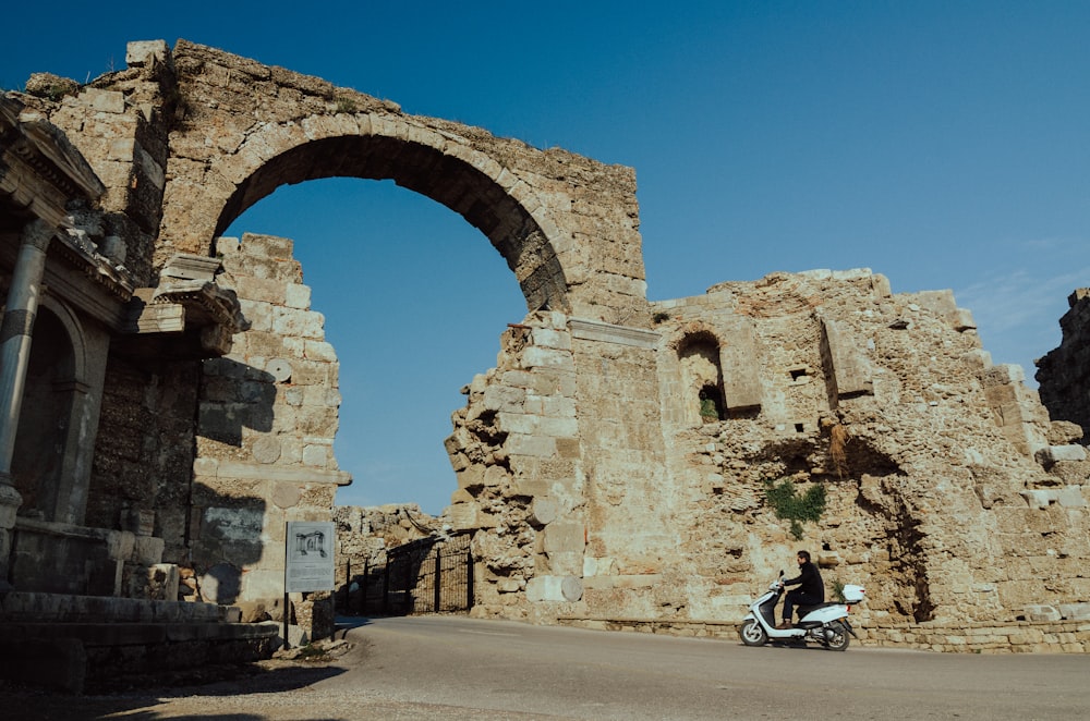 a stone building that has a large rock