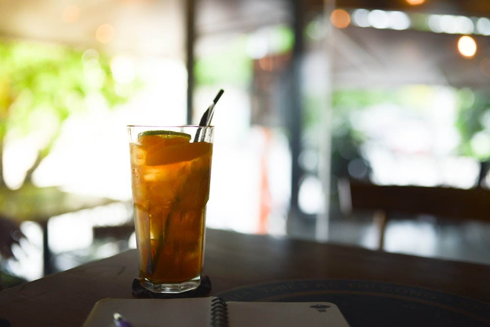 a drink with a straw in it sitting on a table