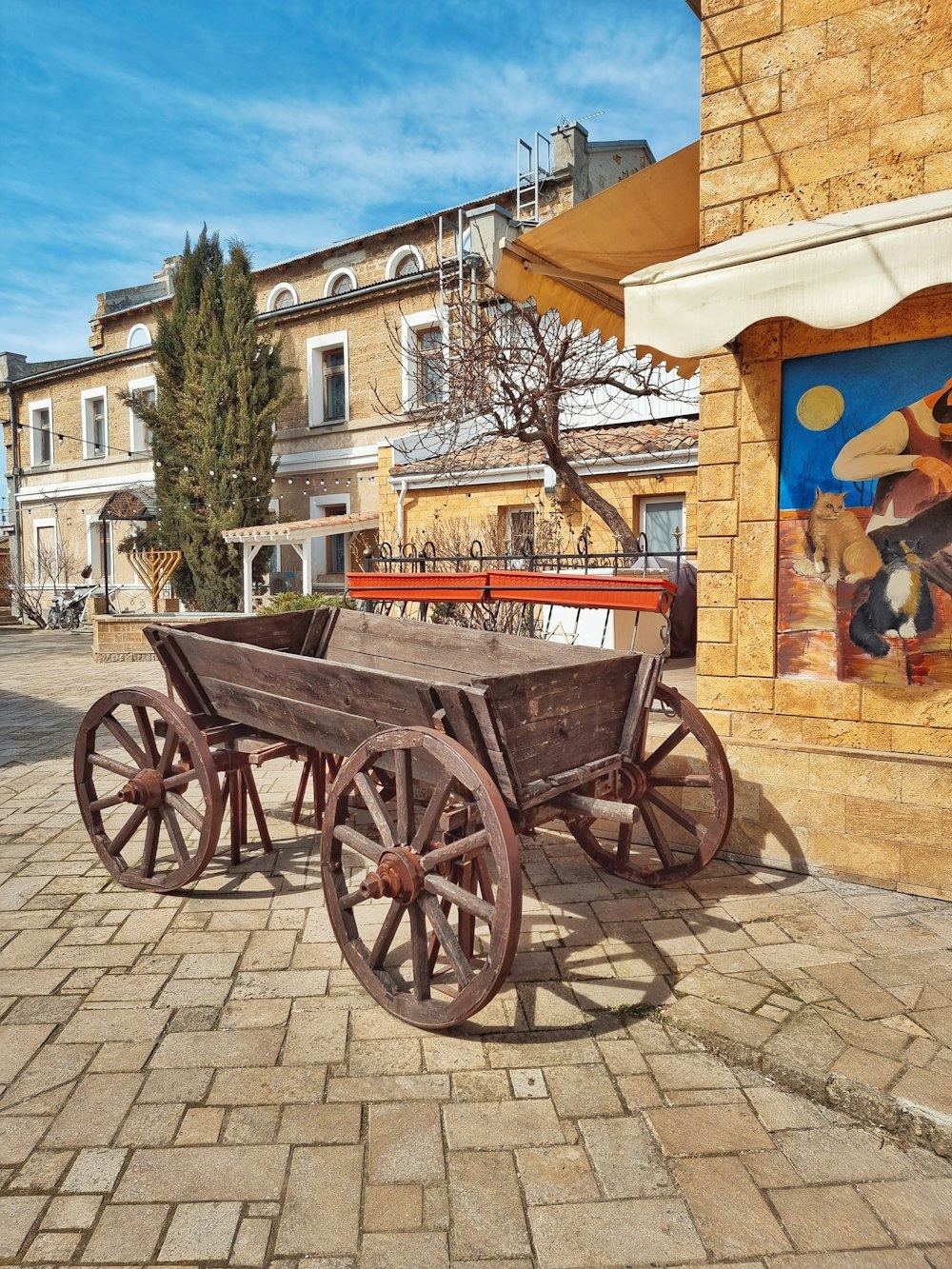 a wooden wagon sitting on top of a brick sidewalk