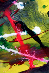 Abstract canvas featuring vibrant splatter paint in reds, blues, and yellows.