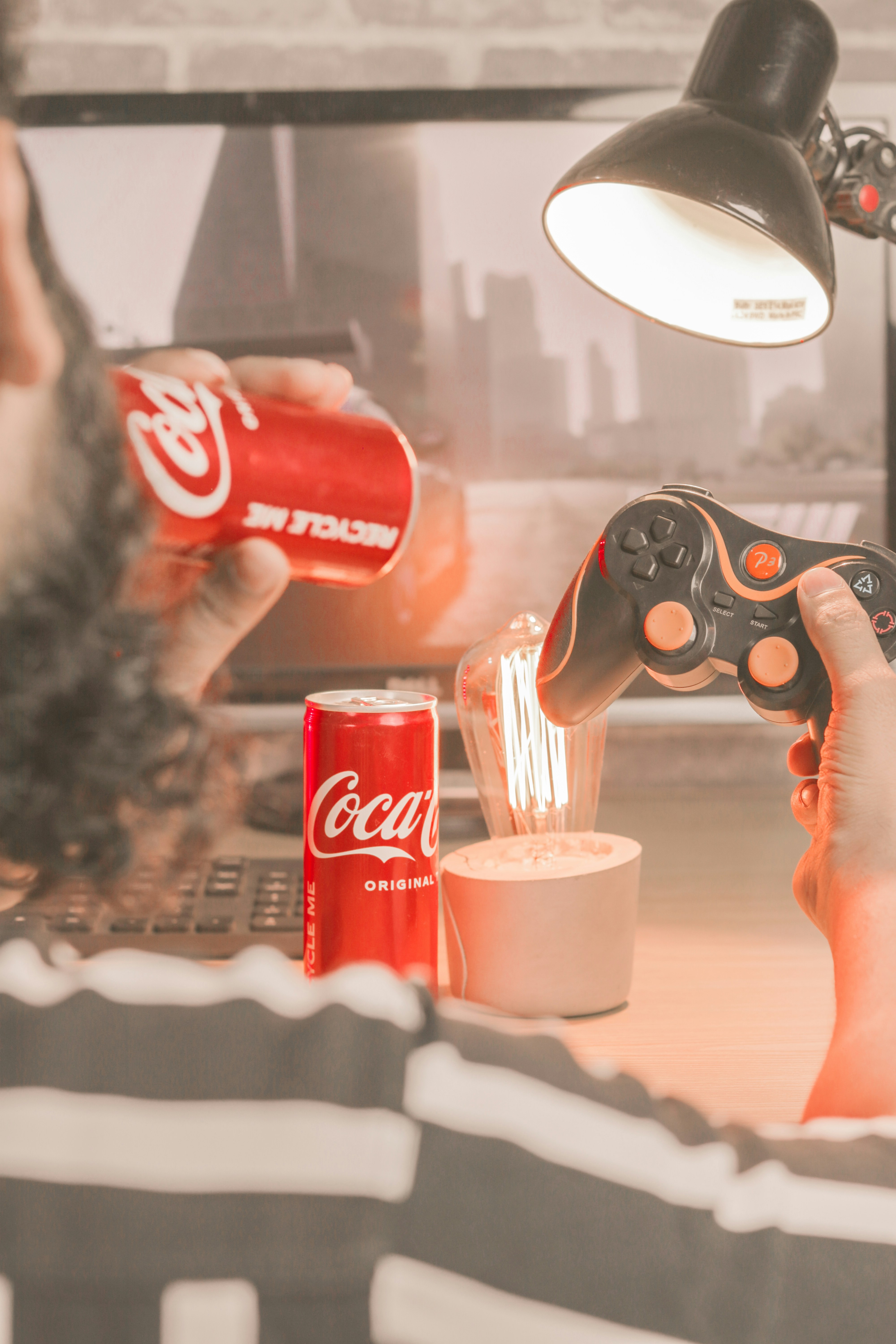 a man sitting at a desk with a remote control