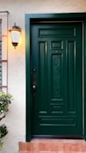 a green front door on a white house