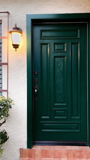 a green front door on a white house