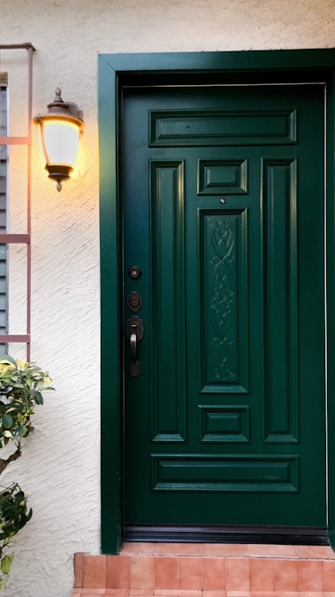 a green front door on a white house