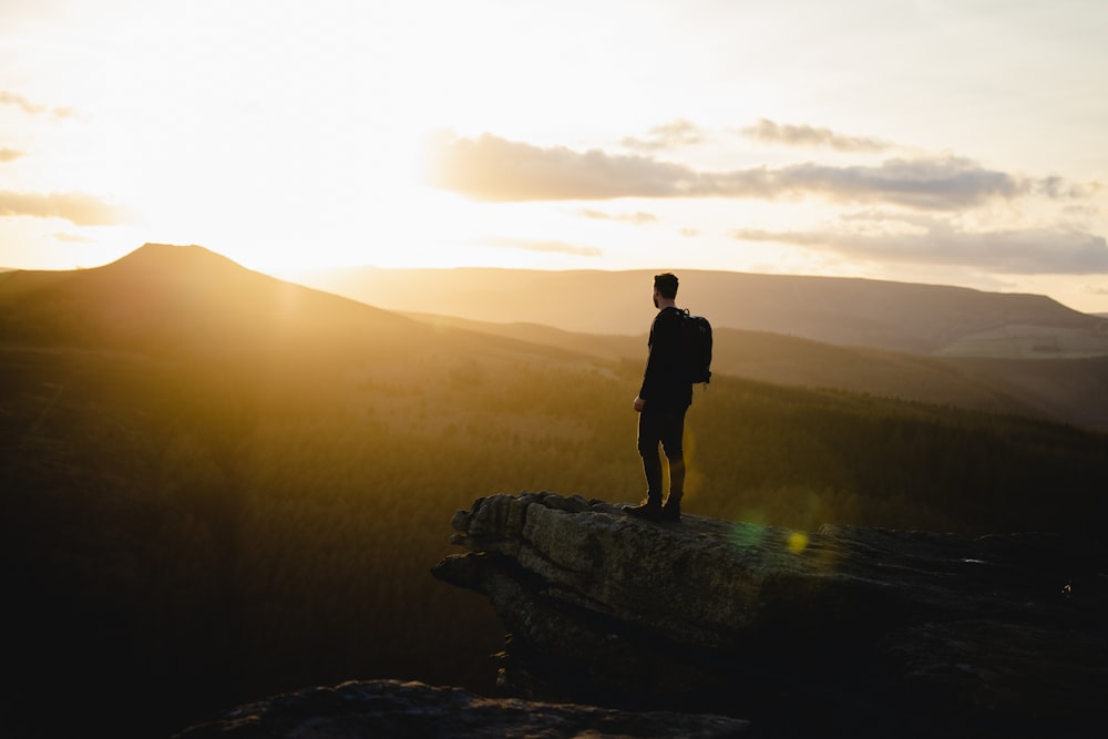 a man standing on top of a tree trunk