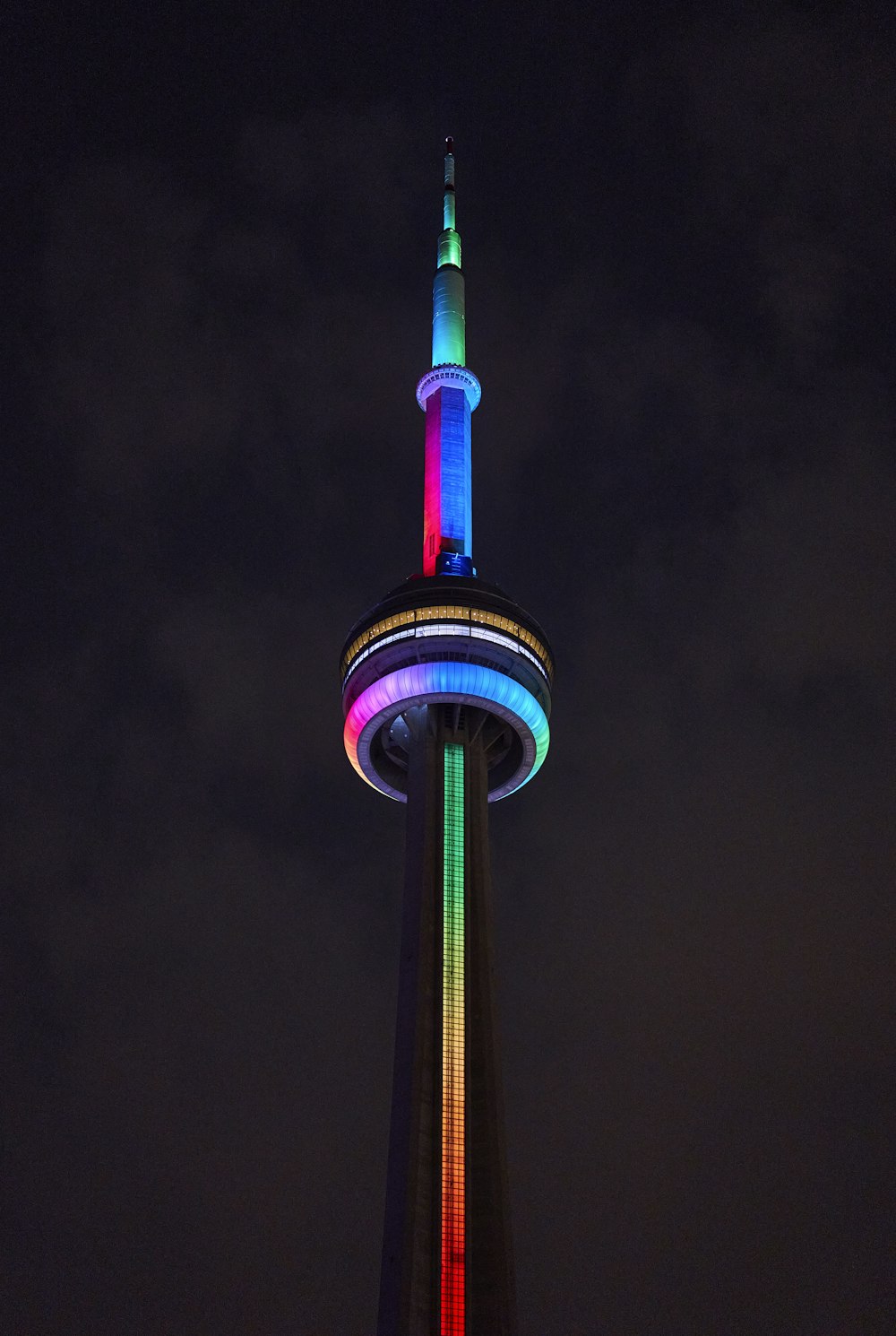 a tall tower with a rainbow light on it's side
