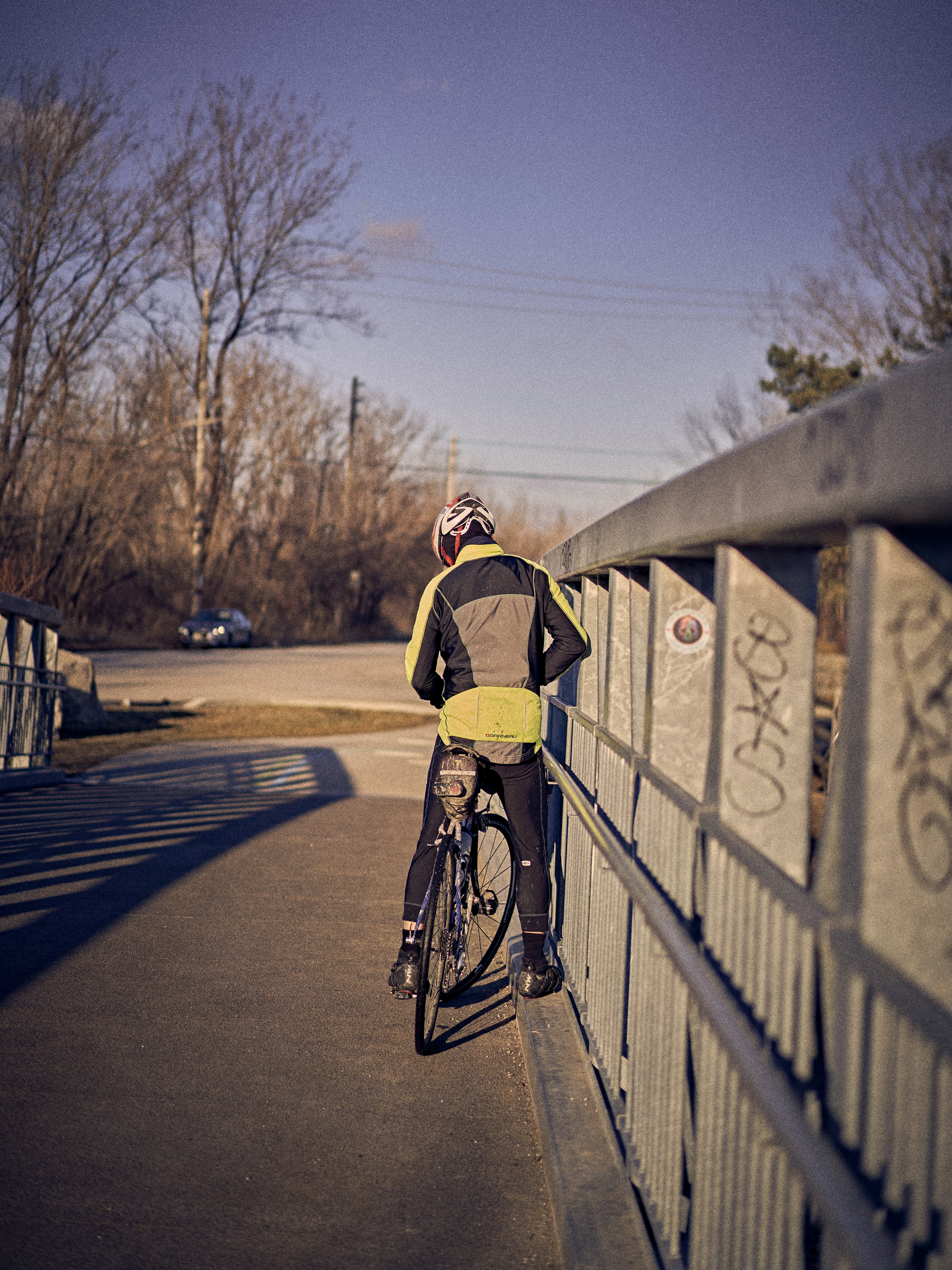 a man riding a bike over a bridge