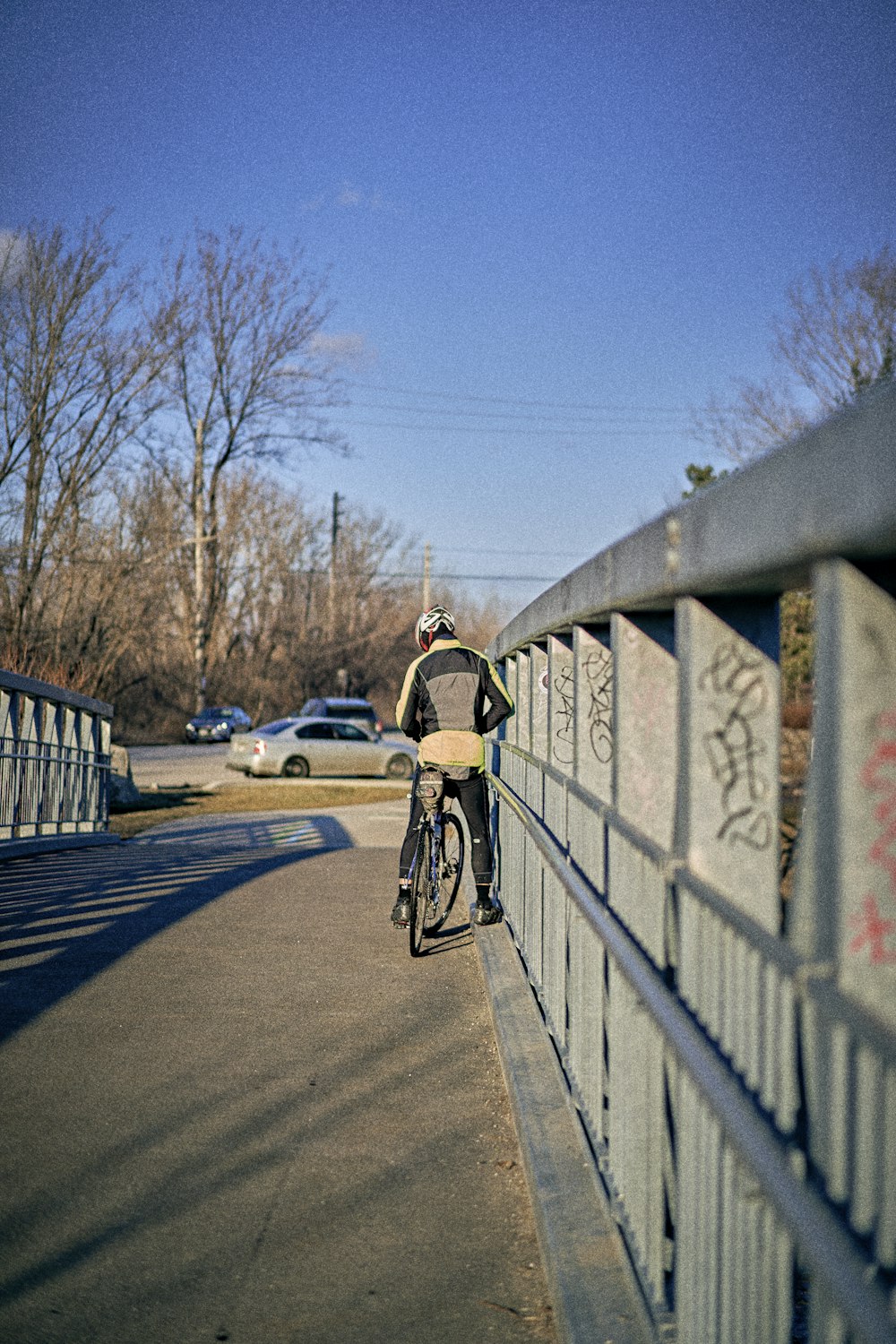 a man riding a bike across a bridge