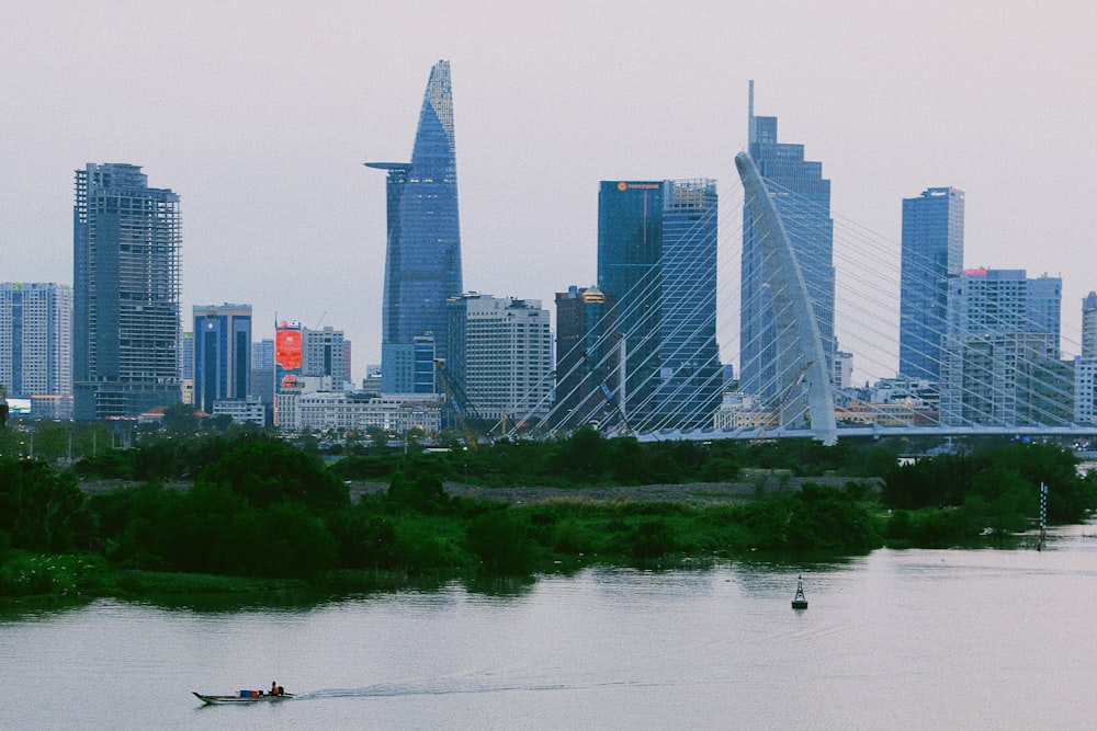 a boat in a body of water with a city in the background