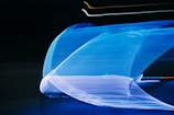 A dynamic display of flowing blue light streaks against a dark background, creating a sense of motion and speed. The lights form abstract patterns with lines and curves, offering a futuristic and vibrant aesthetic.