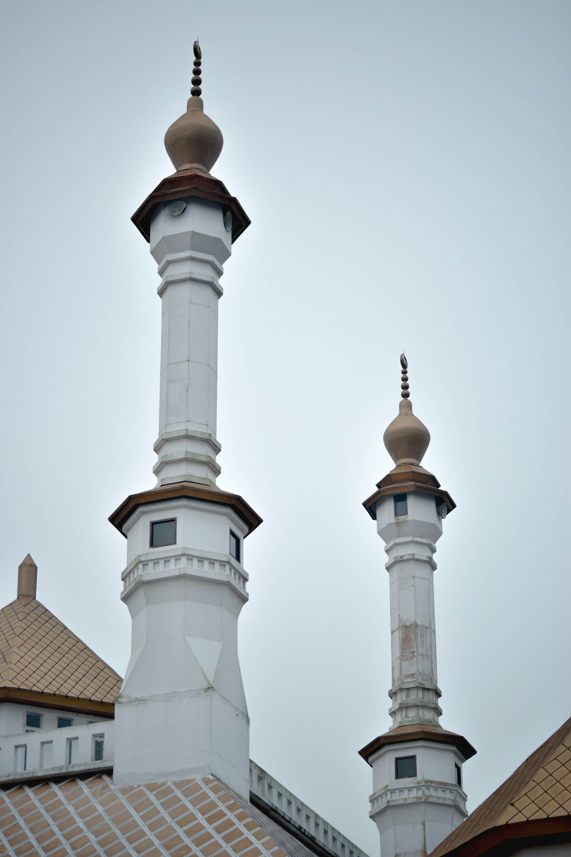 a couple of tall white buildings sitting next to each other