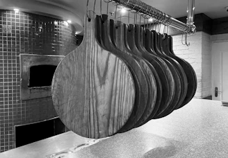 a bunch of wooden spoons hanging from a rack