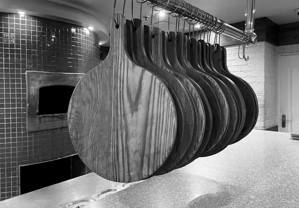 a bunch of wooden spoons hanging from a rack