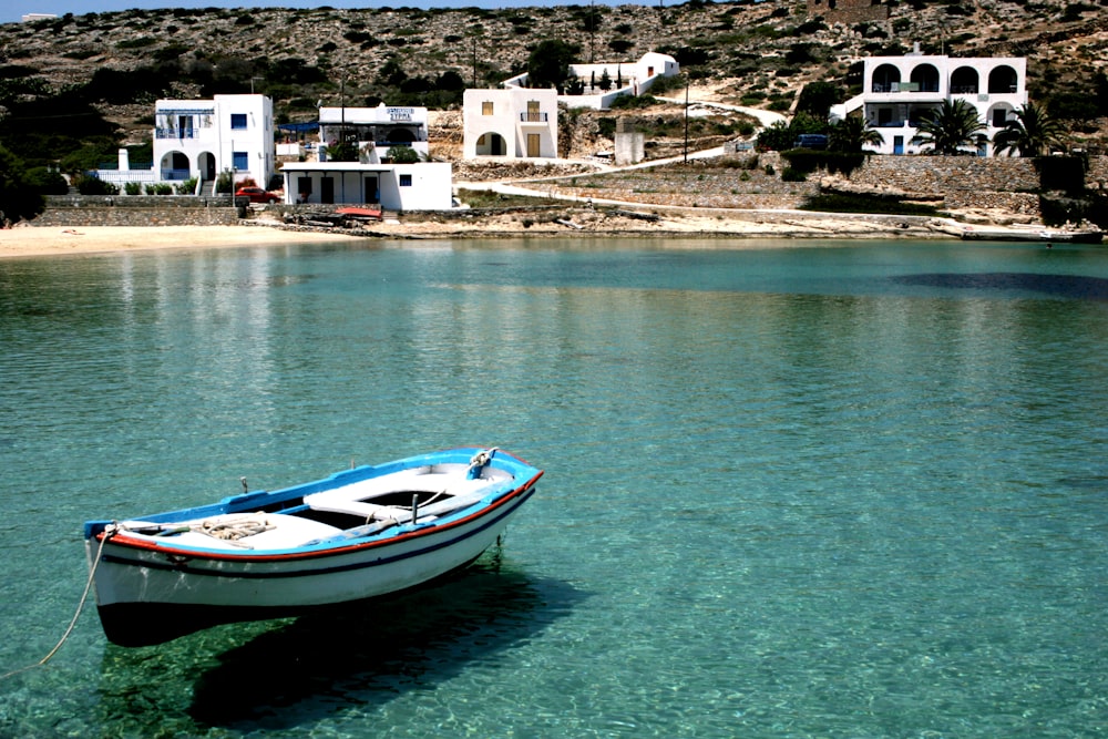 a small boat floating on top of a body of water