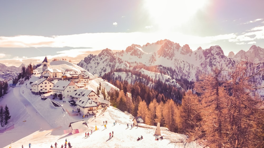 a group of people standing on top of a snow covered slope